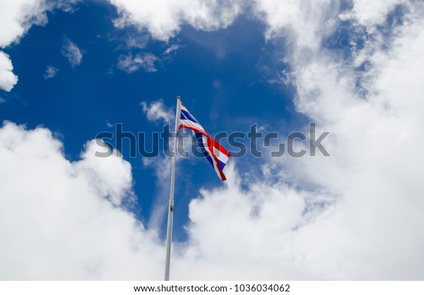 thailand-flag-waving-on-blue-600w-1036034062.jpg